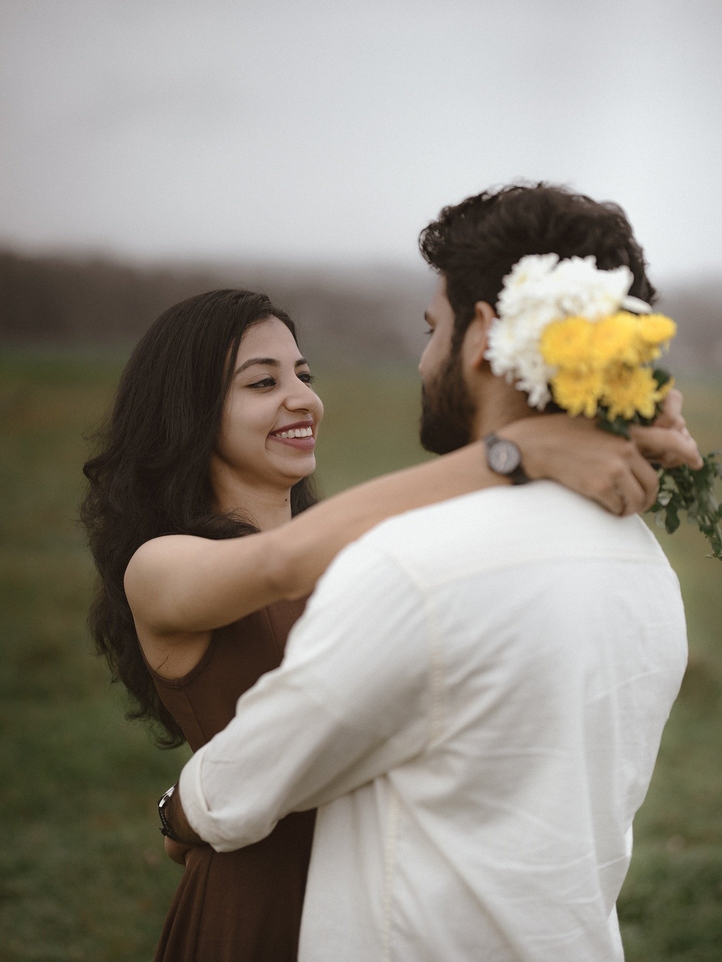 A couple embracing in a field
